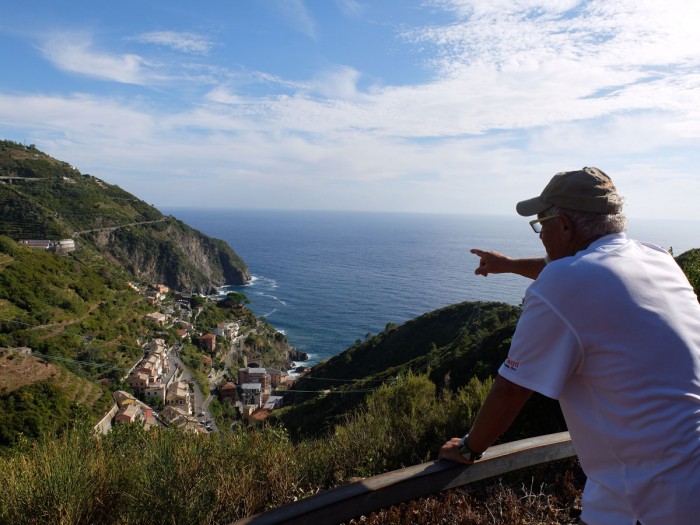 Pall pointing out features of Riomaggiore from afar